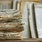 Why do old newspapers eventually turn yellow?