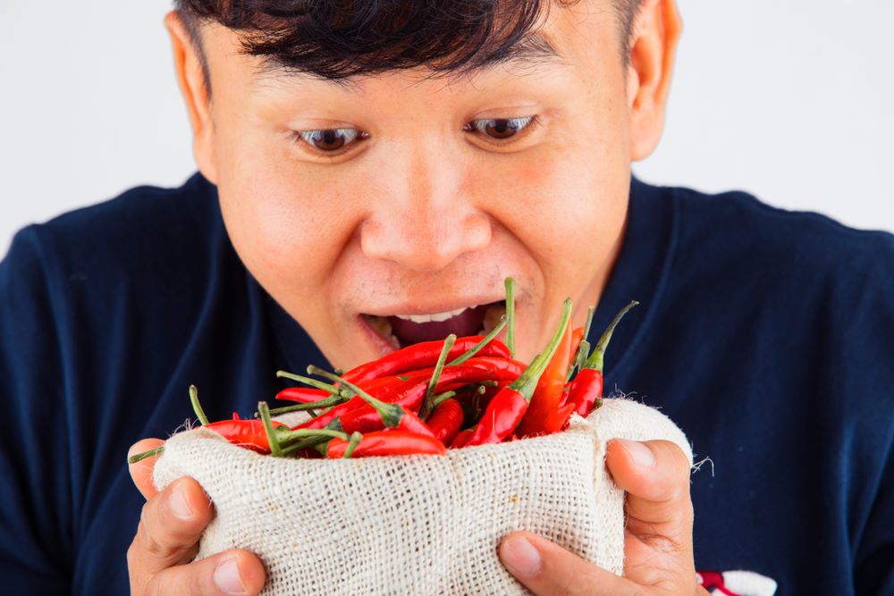man holding chillies